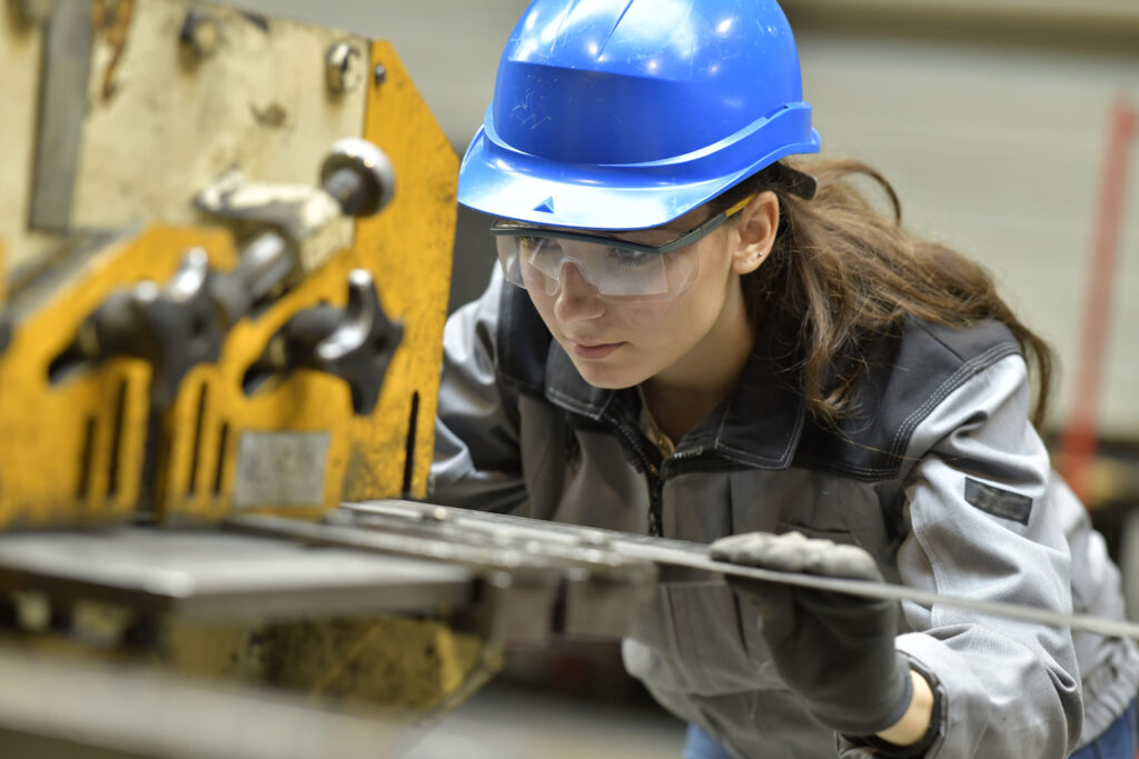 apprentice - female apprentice using steelworks machine
